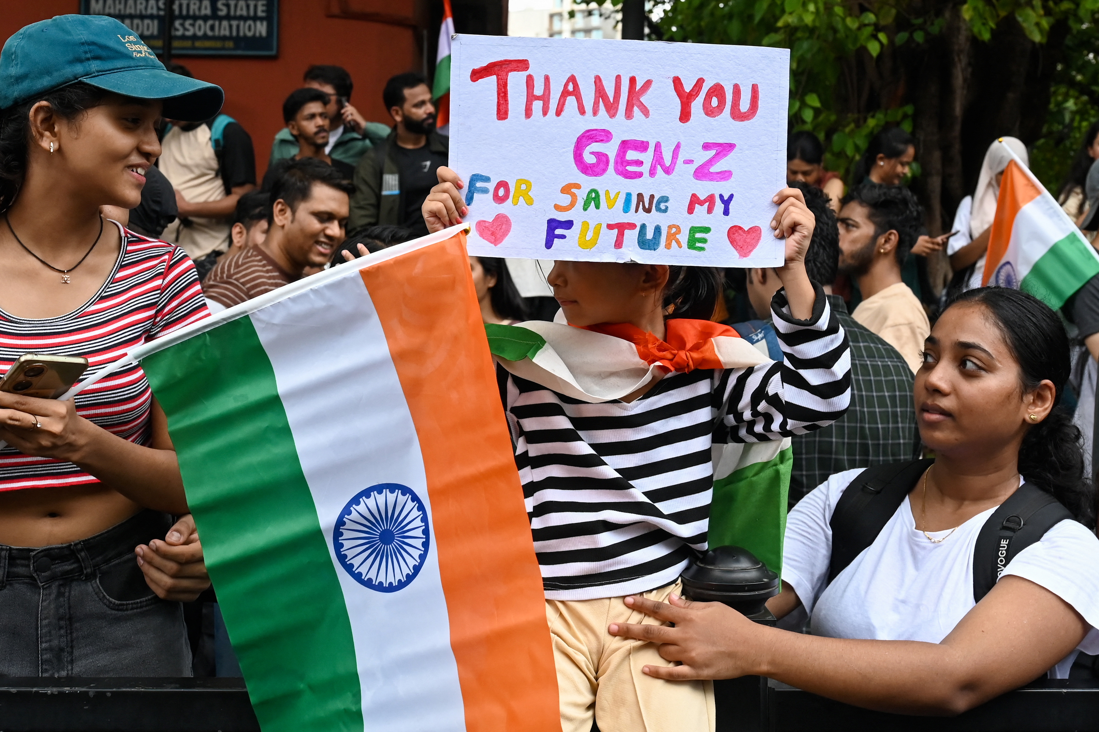 A child holds a placard during a gathering in solidarity with Cockroach Janta Party (CJP) to celebrate the resignation of India